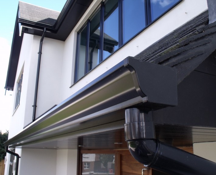 Close-up of Seamless Aluminium Gutter and PVC Drain Pipe