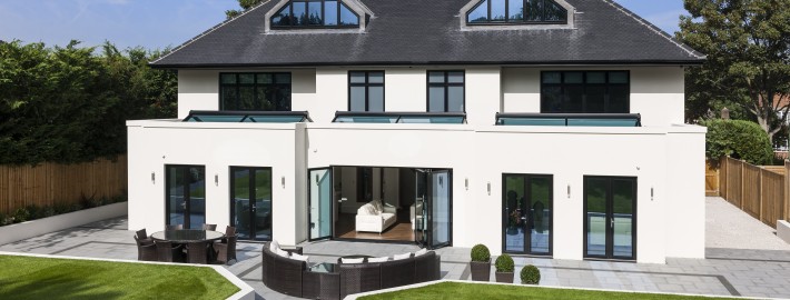 Roofline shot showing black seamless aluminium guttering, Black PVC drain pipes, Black UPVC Fascias and Soffits