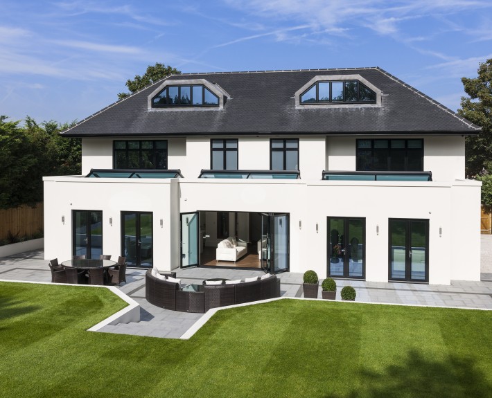 Roofline shot showing black seamless aluminium guttering, Black PVC drain pipes, Black UPVC Fascias and Soffits