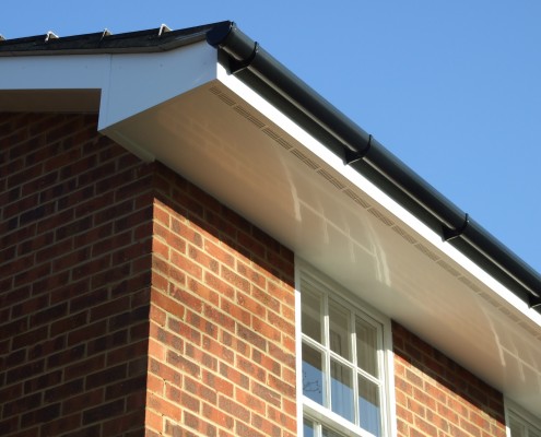 White UPVC Ventilated Soffit with Black PVC Guttering Long Shot