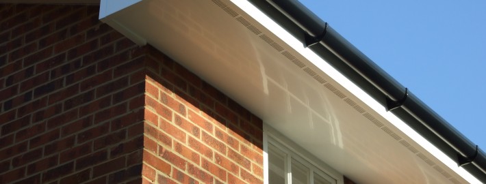 White UPVC Ventilated Soffit with Black PVC Guttering Long Shot