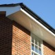 White UPVC Ventilated Soffit with Black PVC Guttering Long Shot