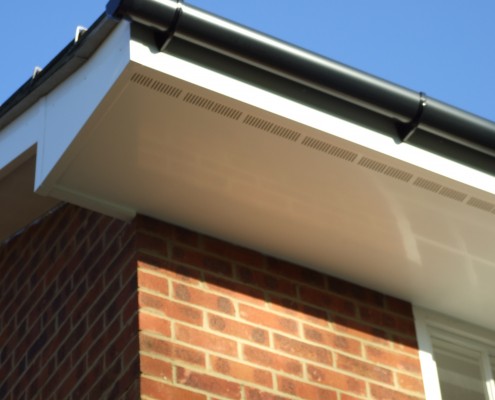 White UPVC Ventilated Soffit with Black PVC Guttering