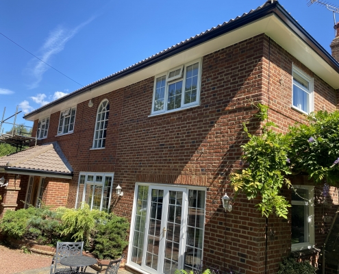 White Fascias and Soffits with Black Seamless Aluminium Gutters in Leatherhead Surrey 1